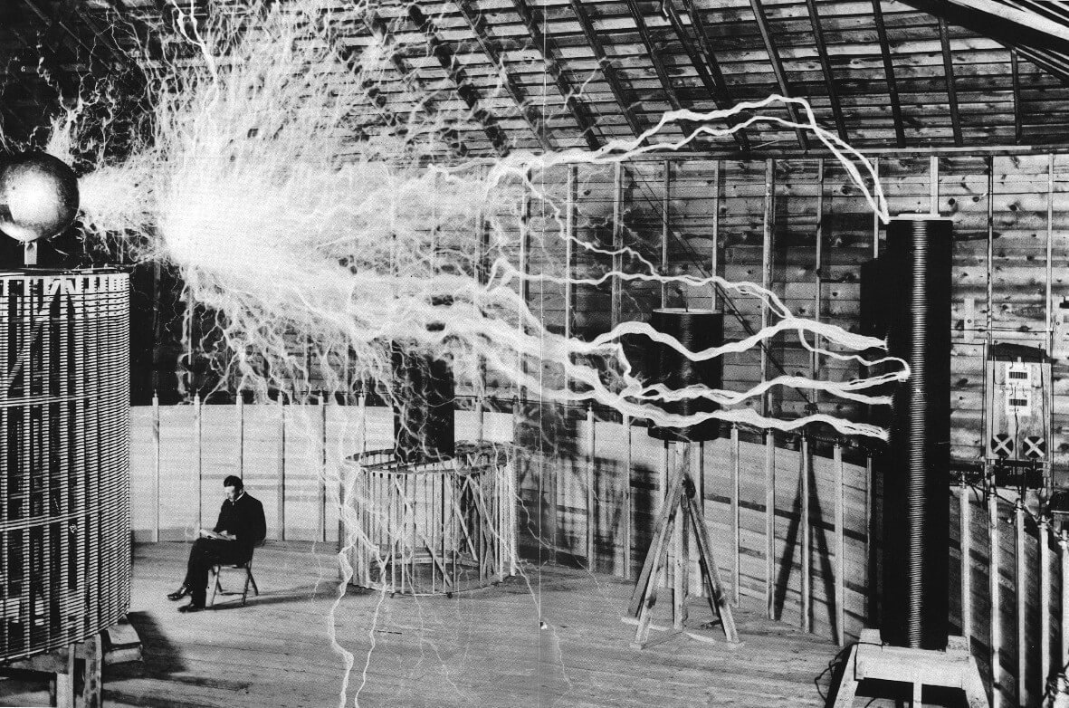 A multiple exposure picture of Tesla sitting next to his magnifying transmitter generating millions of volts. The prohibition of Tesla inventions is a clear example of Medusa.